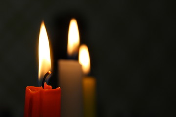 Red candle on dark background