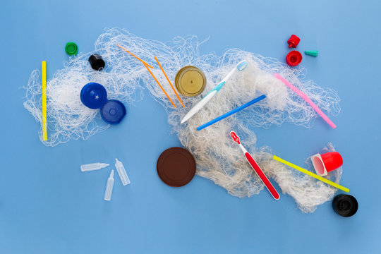 Assortment of obsolete plastic garbage items on colorful background