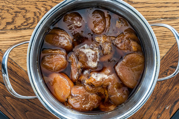 Homemade Compote of Dark Sun Dried Apricots in Pot / Komposto.