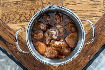 Homemade Compote of Dark Sun Dried Apricots in Pot / Komposto.