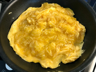 Omelette with Grated Potatoes in Pan. Ready for Breakfast.