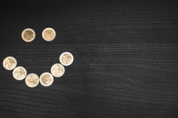 2 euro coins on dark wooden table