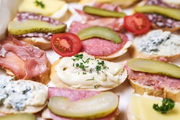 Simple sandwiches with cheese and sausage for a casual party