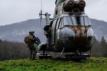 French soldiers from the 27th Alpine Fighter Regiment with a land force helicopter doing training...