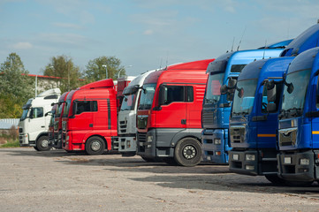 Fototapeta na wymiar Row of trucks parked on a large parking lot