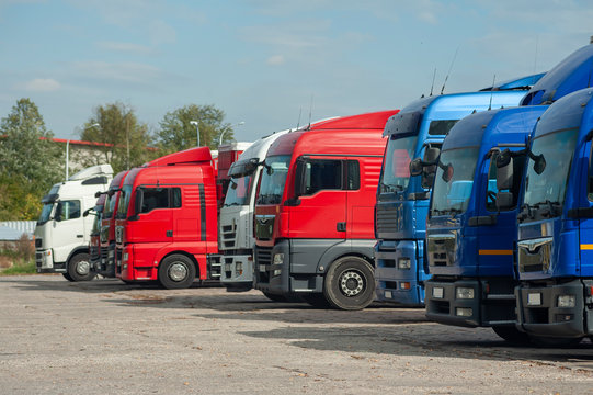 Row of trucks parked on a large parking lot