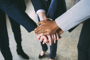 Closeup shot of creative team putting hands together. Cropped shot of women putting hands together in circle. Teamwork concept