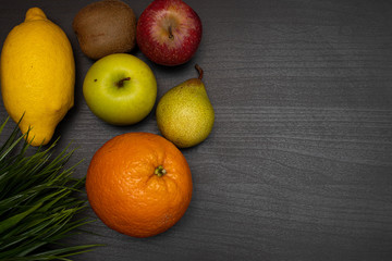 fresh fruit on dark wooden table representing healthy food