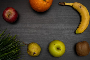 fresh fruit on dark wooden table representing healthy food