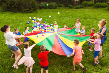 Birthday games on fresh air with parachute and balls