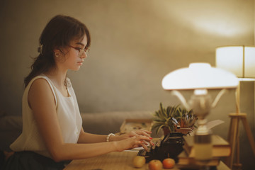 Woman Writer Working on a Typewriter