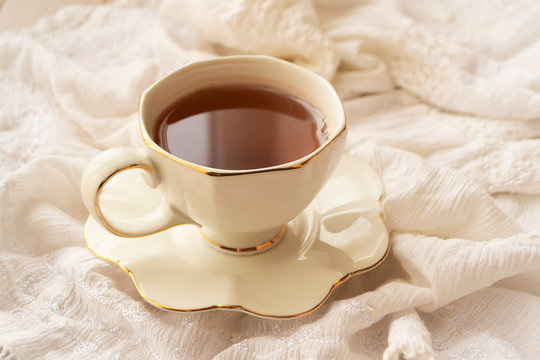 Antique porcelain tea cup on white background, mornong elegant image