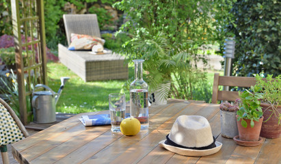 close on drink and apple on a wooden table in garden  background in summer