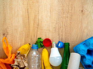 Different garbage on wooden background, top view. Reuse, reduce, recycle concept