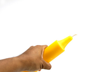 Use the hand to hold the yellow candle isolated on white background.