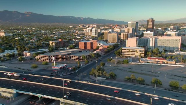 Tucson, Arizona, USA. 29 April 2020: Aerial flying over freeway & downtown Tucson at sunset.