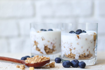 Granola with yoghurt in glass glasses, healthy breakfast