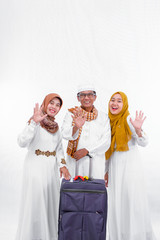 portrait of asian muslim family with one adult daughter smile and waving getting ready for celebrating ramadhan holiday isolated over white background