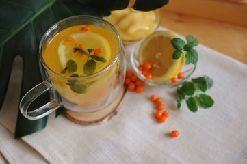 Recovery tea after disease with vitamins - buckthorn tea with lemon and honey.