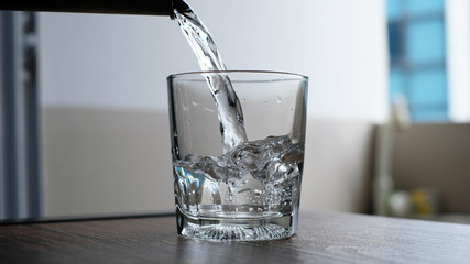 water to drink poured into a glass