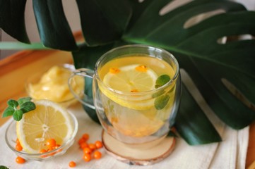 Hot drink tea during disease with vitamins - buckthorn tea with lemon and honey.