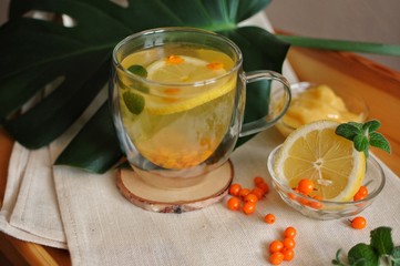 Recovery tea after disease with vitamins - buckthorn tea with lemon and honey.