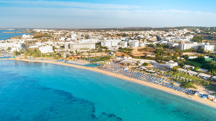 Aerial bird's eye view of Pantachou - Limanaki beach (Kaliva), Ayia Napa, Famagusta, Cyprus. The landmark tourist attraction bay with golden sand, sunbeds,sea bar restaurants in Agia Napa from above.