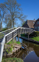 Fototapeta na wymiar Giethoorn Overijssel Netherlands. During Corona lock-down. Empty streets, paths, bridges and canals. Old farmhouse