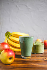 Smoothie with fresh red apple, banana and spirulina powder. Summer vitamin refreshing drink. Healthy detox diet