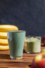 promotional shooting of a fruit cocktail for a healthy eating establishment. In the photo, a glass with a green drink made from fruits and algae spirulina powder