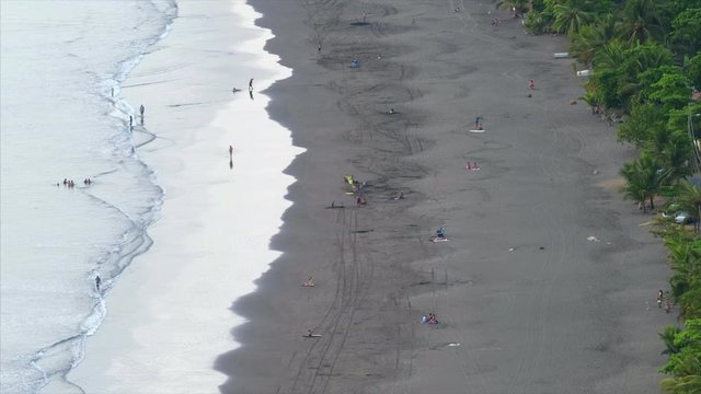 Sandy beach during low tide. Town of Jaco in Costa Rica