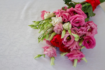 Beautiful bouquet of freshly cut flowers on a white tablecloth.