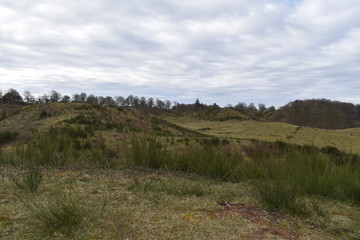 Fototapeta premium Hills, trees and clouds in early spring in Denmark