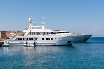 Fototapeta na wymiar Luxury yachts mooring at the port of Rhodes in Greece