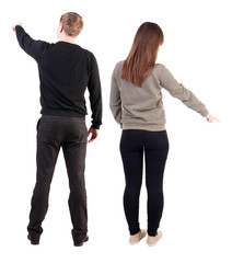 Back view of couple in sweater pointing.