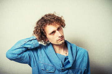 Man holding his hands behind his head