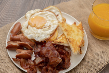 Full American Breakfast with fresh orange juice on wooden table - Stock photo
