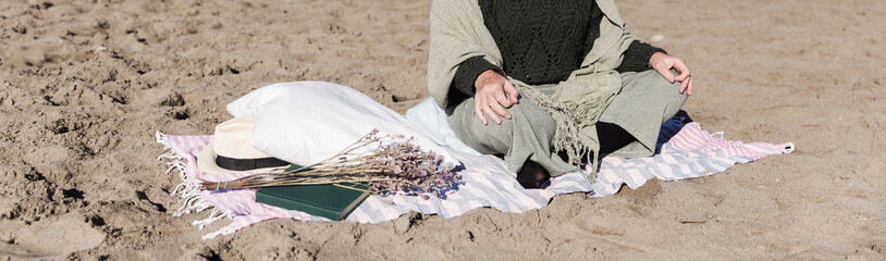 Unrecognizable adult meditating outdoors. Mindfulness concept.