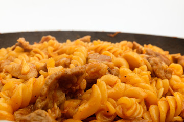 Fusilli pasta on white background