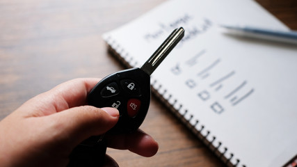 Female holding car keys with mortgage checklist car, business concept.