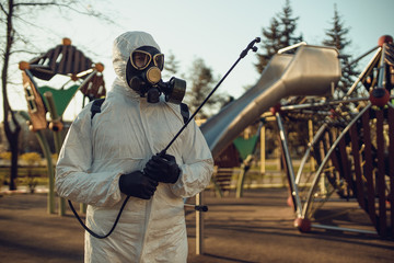 Cleaning and Disinfection on the playground in the sity complex amid the coronavirus epidemic Teams for disinfection efforts Infection prevention and control of epidemic Protective suit and mask