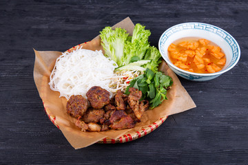 Grilled chicken breast served with noodles, salad leaves and fresh vegetables, with broth and chips