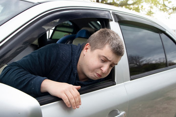 A ride during a car trip. The driver suffers from kinetosis, motion sickness. The concept of motion sickness in transport and vestibular apparatus disease