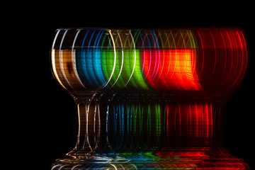 moving glass changing color on a black background, blur and strobe