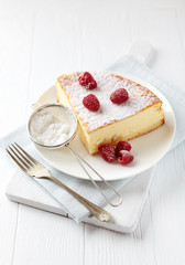 Piece of cheese cake on bright background. Bright wooden background. 