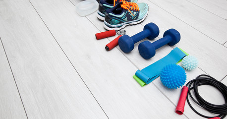 The fitness tools and  a equipment on the wooden floor. Concept of home physical training and staying at home