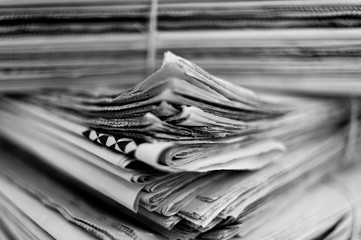 stack of newspapers on black