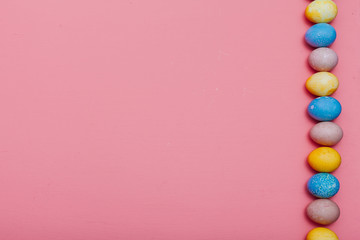 Obraz premium multi-colored eggs for the Easter holiday on a pink background