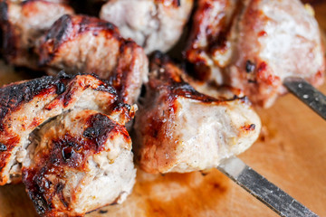 delicious pork kebab, shashlik or kebab, skewer closeup on a wooden cutting Board