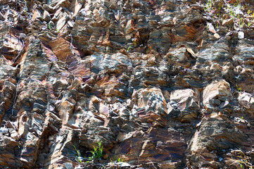 Background in the form of rock with large fragments of gray, yellow and purple hues